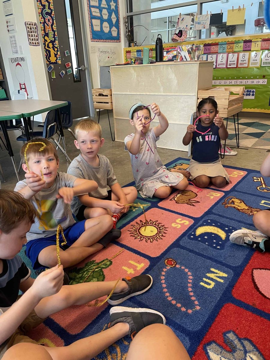 Young Selwyn students sitting in a circle on the classroom rug