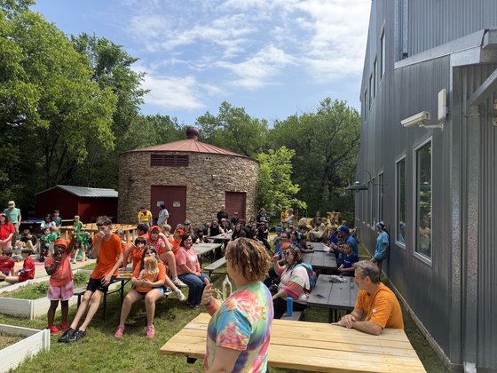 The Selwyn community gathered on benches outside the round stone silo on the Argyle campus